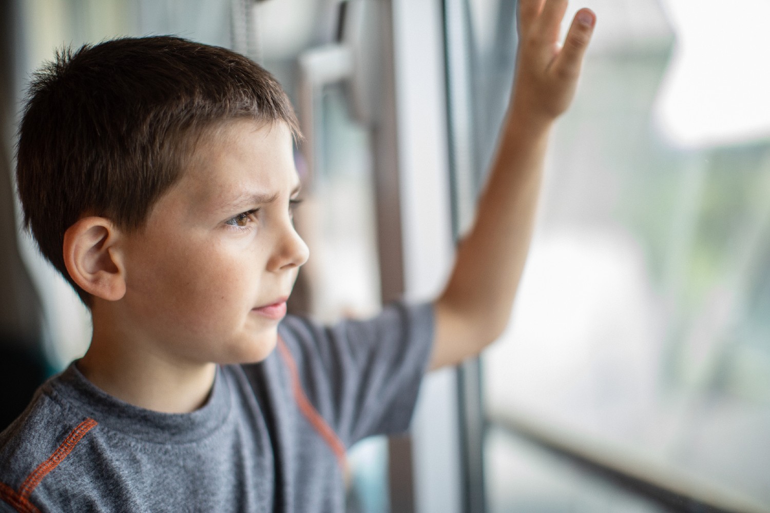 A boy looking out the window. 