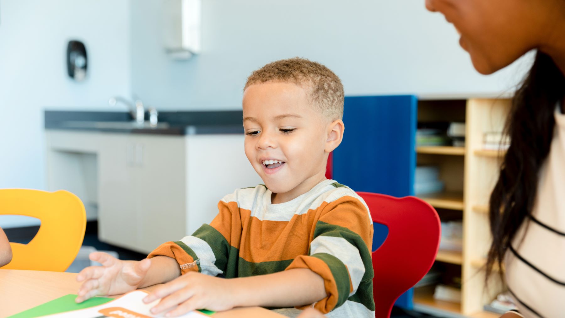 young boy smiles in therapy session