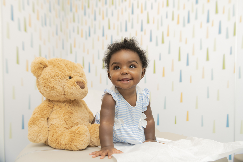 smiling baby with teddy bear