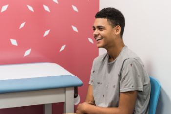 smiling teenaged boy in doctors office
