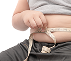 child measuring his stomach