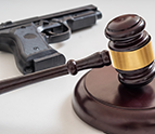 gavel in front of a pistol