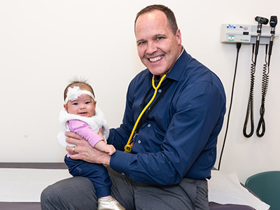 Dr. Timothy Kane with baby Kinsley Feigel