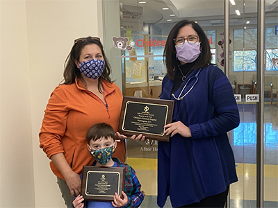 Mended Little Hearts’ Volunteer of the Year, Maryann Mayhood, and her son Joseph delivered the Hospital of the Year award to Dr. Donofrio in November 2020.