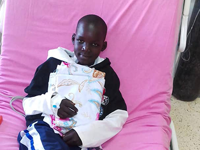 Ugandan boy in hospital bed