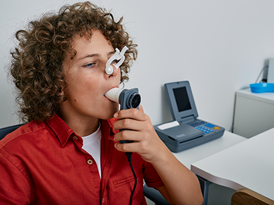 boy using spirometer
