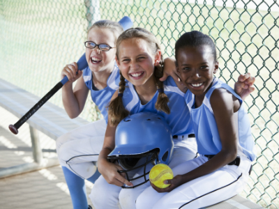 girls softball team sitting in the dugout