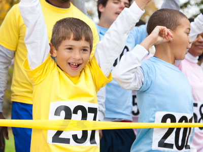 kids crossing a race finish line