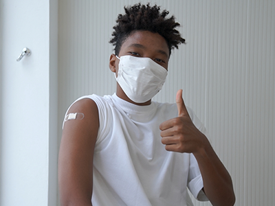 boy giving thumbs up after getting vaccinated
