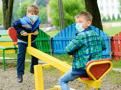 boys wearing masks in playground