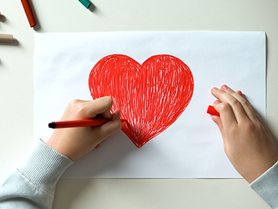 child drawing a heart