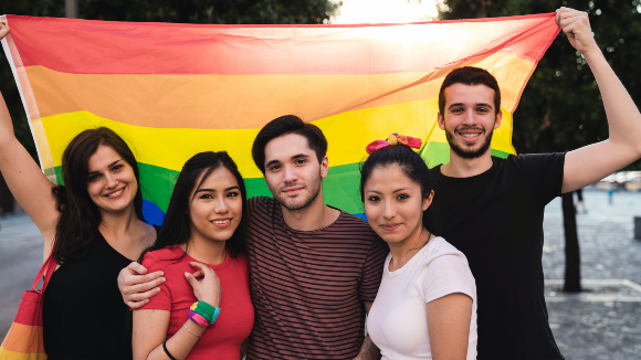Teens holding rainbow flag