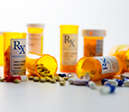 assorted perscription pill bottles and pills