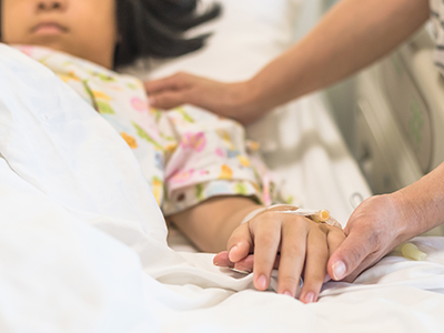 sick child in palliative care hospital bed