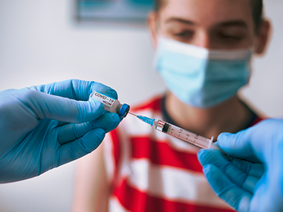 doctor vaccinating a teenage boy