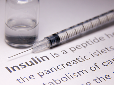 needle and piece of paper with insulin description