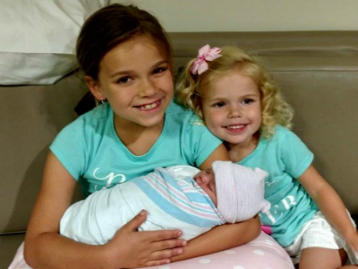 Penelope as newborn and sisters 