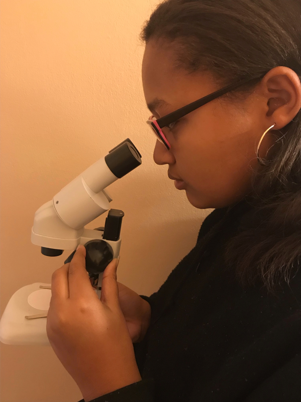 Gabriella using a microscope