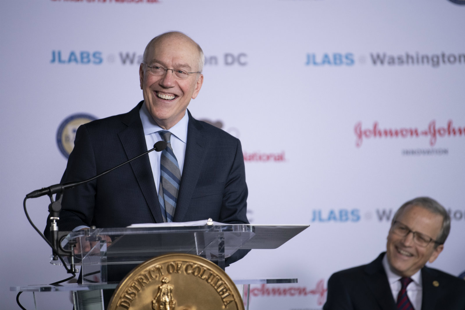 Dr. Newman chuckles at the podium during April 9, 2019, press conference.