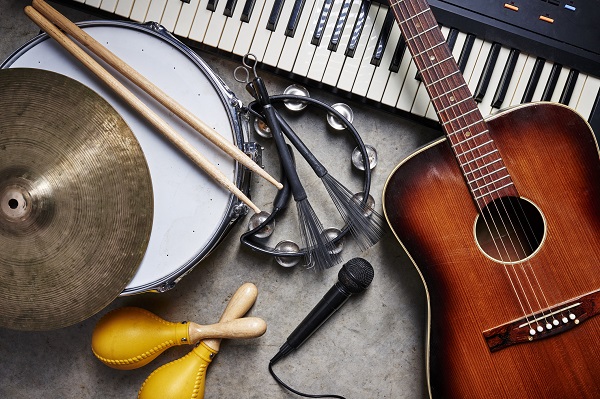 A guitar, drum, tambourine, keyboard, cymbal, maracas and microphone.
